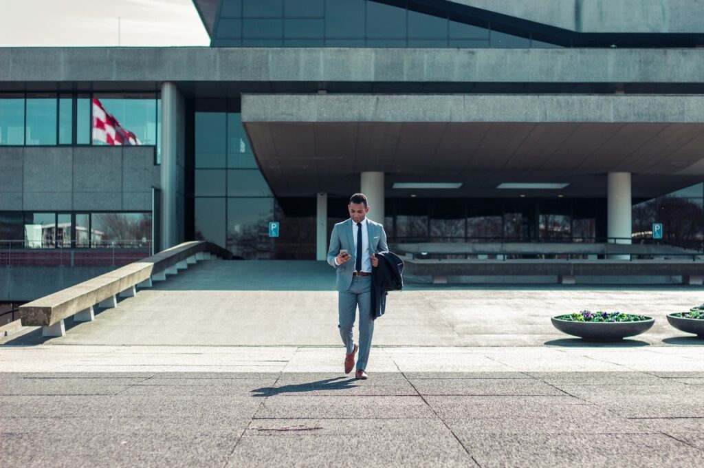 Man in suit walking out of a building
