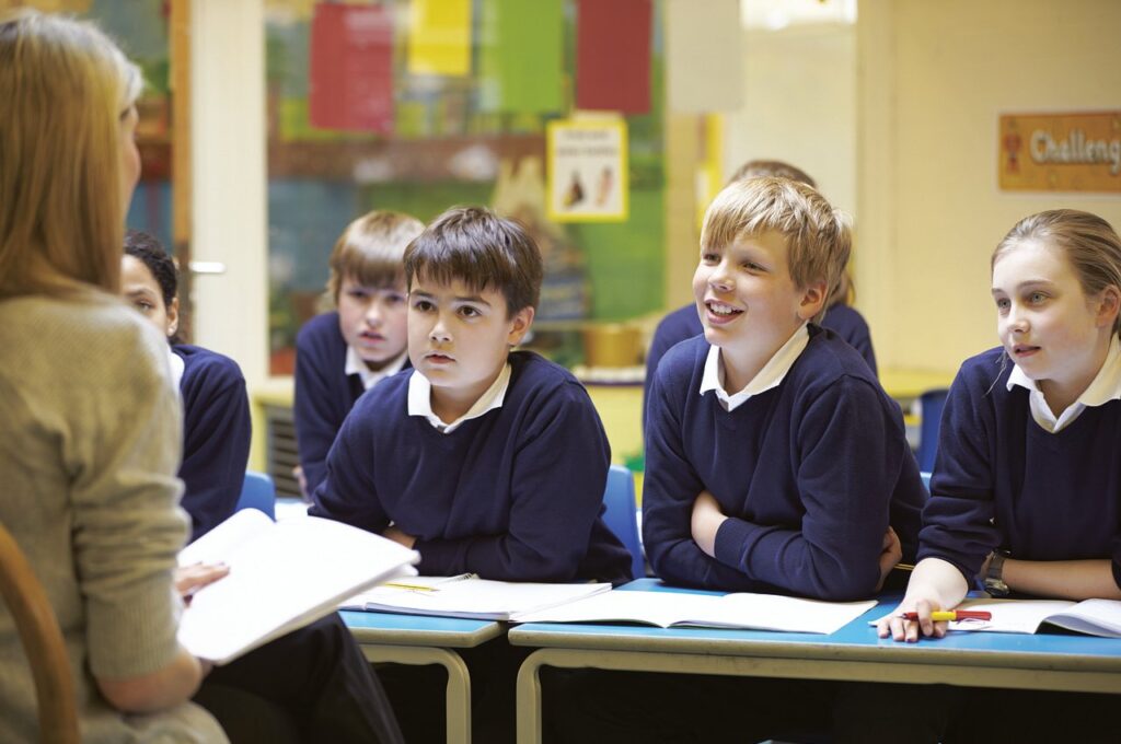 a teacher teaching children in the classroom