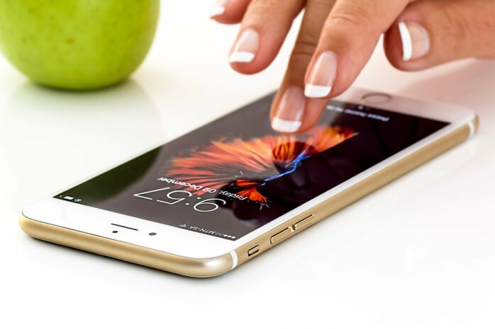woman's hand touching iphone