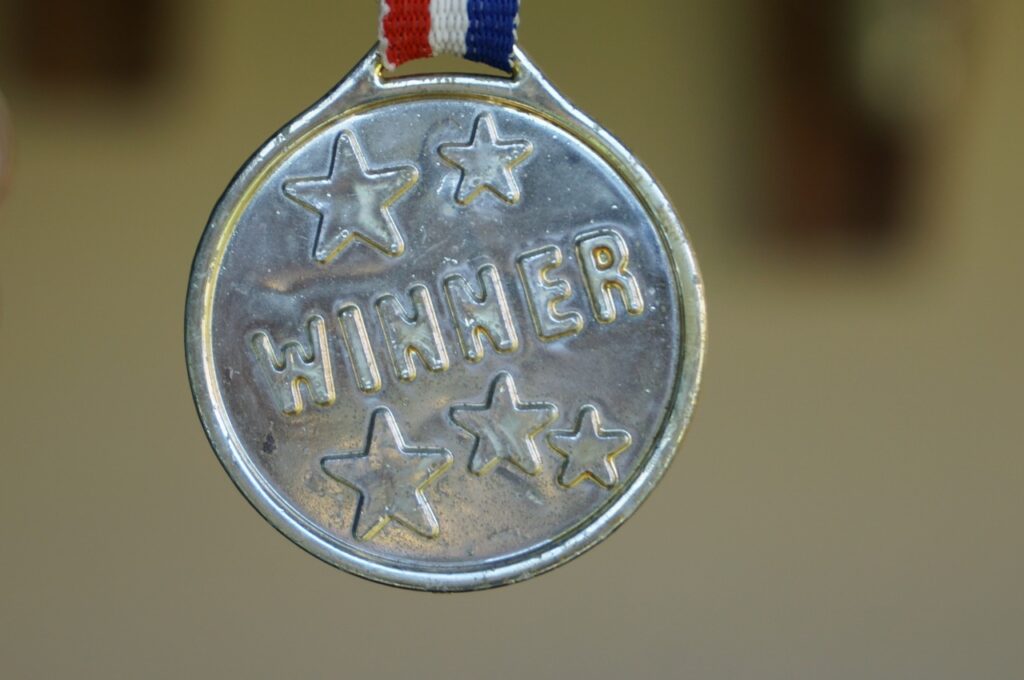 a silver medal with the word winner printed on it